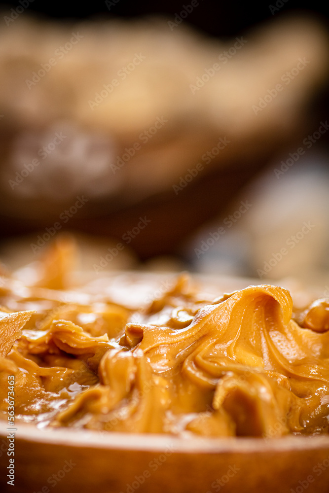 Wall mural Peanut butter on a plate. Macro background.