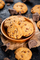 Delicious cookies with pieces of milk chocolate on a plate.