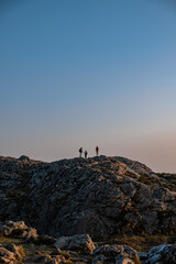 silhouettes of people on top of the mountain at dusk, view from Bray Head, Ireland