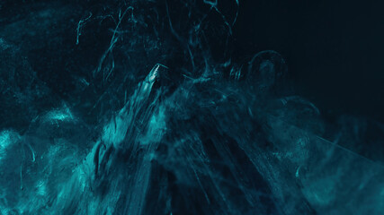 Steam splash. Smoke cloud. Mountain hill. Defocused turquoise blue color mist floating over glass pyramid angle on dark abstract background.