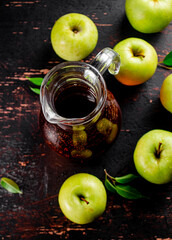 Fresh apple juice. Against a dark background.