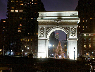 Fototapeta premium A view of the Empire State Building as seen from under the arch at Washington Square Park at Christmas time in New York City.