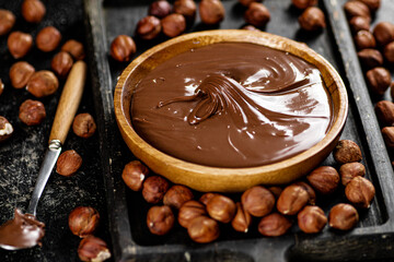 Hazelnut butter on a cutting board with a spoon. 