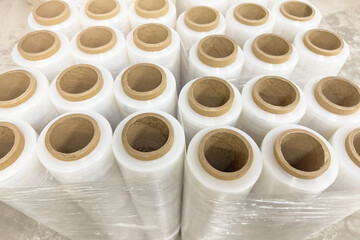 Roll of industrial packaging film. Stretch film in rolls stands in a row. The use of film as a packaging material. Place for text with copy space.