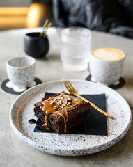 Brownie with a flat white on a coffee shop table