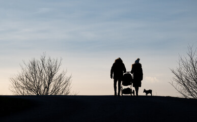 Parents with a stroller on a walk outside