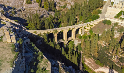 Canyon of Gravina with the old aqueduct stone bridge. Apulia region, Italy
