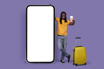 Happy african american guy traveller standing by smatphone, mockup