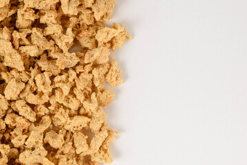 Uncooked dry textured soy protein or vegan meat isolated on white background with copy space