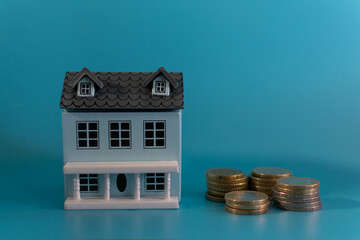 wooden house and coins, the concept of buying a home
