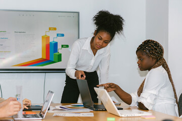 Obraz premium Diverse colleagues gather in brainstorm discuss statistics together. Group of people colleagues gather doing Brainstorming business plan together. Team Brainstorm Working Concept.