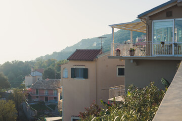 Fototapeta premium Beautiful view of Lakones streets and houses, traditional greek village near Paleokastritsa, Corfu island, Kerkyra, Ionian sea islands, Greece, in summer sunny day with blue sky and mountains
