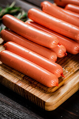 Sausages are delicious on a cutting board. 