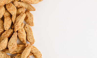 Layer of pieces dry textured soy protein or vegan meat isolated on white background with copy space
