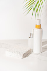 Porous pedestal near the cosmetic tubes on white table. Beauty product presentation. Bathroom shelf...