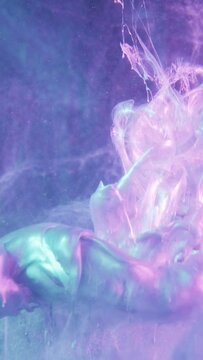 Vertical video. Paint shot. Ink water. Fume texture. Blue pink purple neon color light shiny glitter fluid splash motion on frost surface abstract background.