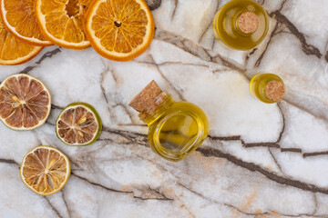 Top View Small Oil Bottle And Dried Citrus Fruits.