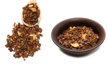 Chocolate granola cereal with nuts in a bowl background.