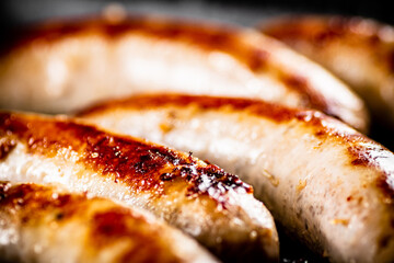 Delicious grilled sausages. Macro background.