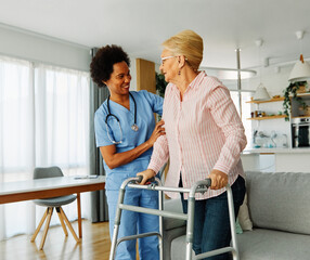 Fototapeta premium nurse doctor senior care caregiver help walker assistence retirement home nursing elderly woman black african american hospital clinic home disability disabled