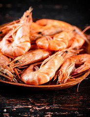 Boiled shrimp in a wooden plate. 