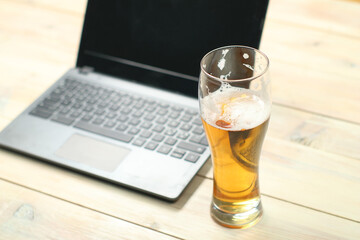 mug of beer on the background of a laptop