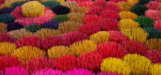 Fototapeta na wymiar Many colors of incense sticks in bunch being dried outside in Hue, Vietnam 