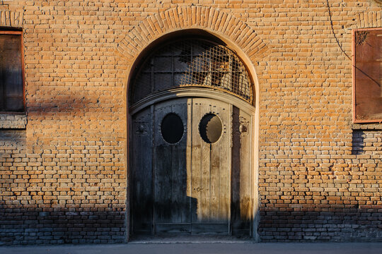 Vintage wooden door on red brick wall