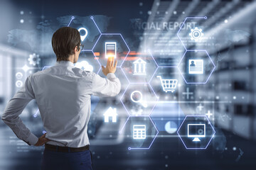 Online banking and financial analysis concept with man back view touching virtual screen with digital social icons on hexagon cells on blurry office background