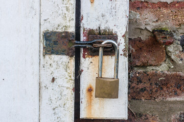 Padlock locking a steel bolt lock on a sliding door shed barn workshop, County Down, Northern Ireland, United Kingdom, UK