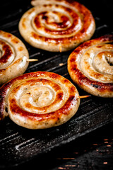 Grilled sausages in a frying pan. 