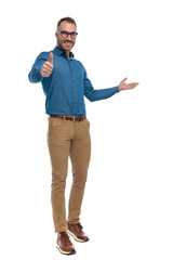 attractive young man with glasses making thumbs up gesture and inviting to side