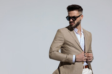 businessman with masculine frame opening his jacket