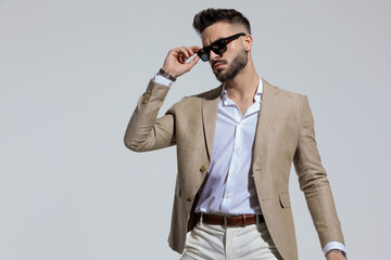 businessman arranging his sunglasses in a fashion pose