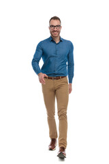 happy casual man in denim shirt with glasses walking and smiling