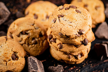 Cookies with pieces of milk chocolate on the table. 
