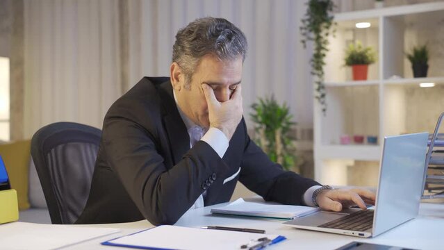 Tired mature businessman with sleepiness falling asleep in his home office.
Tired mature businessman feeling sluggish and falling asleep at the table.
