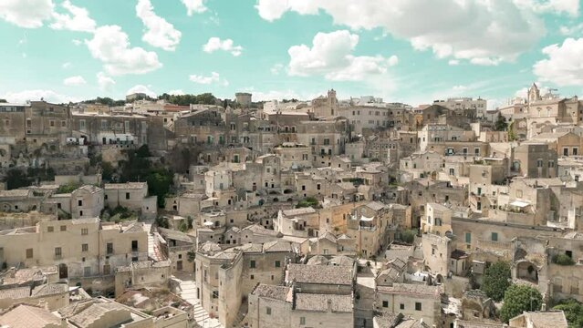 Sassi di Matera historical cityscape, drone flies over the old town
