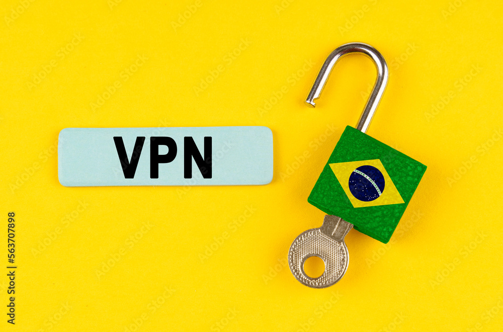 Poster on the yellow surface is an open lock with a key and a sticker with the inscription - vpn