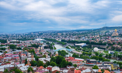 Old Tbilisi cityscape with Mtkvari or Kura river, Cathedral, bridge of peace, Rike park and presidential palace. Tiflis is popular tourist destination in Georgia