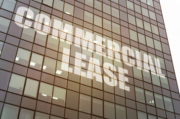 Fototapeta premium On the glass surface of the business center there is an inscription - COMMERCIAL LEASE