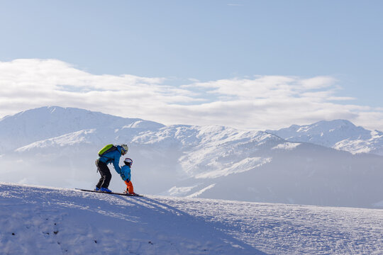 children skiing and snowboarding in the mountains, ski resort