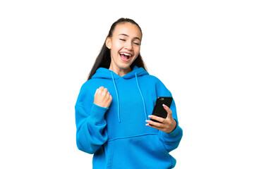 Young Arabian woman over isolated chroma key background with phone in victory position