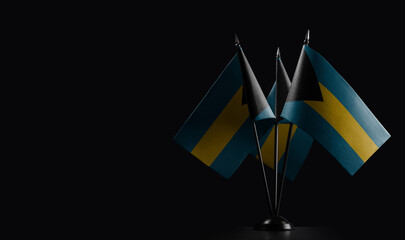 Small national flags of the Bahamas on a black background