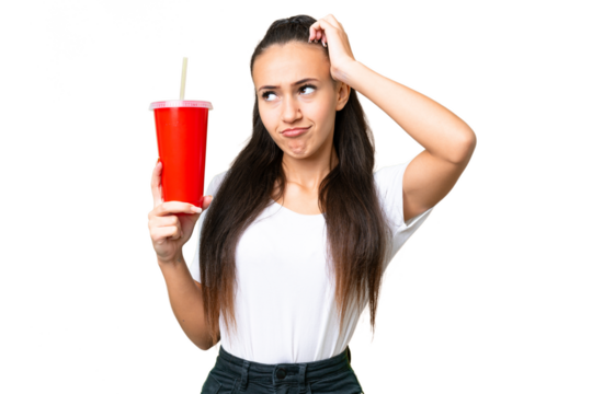 Young Arabian woman holding soda over isolated chroma key background having doubts and with confuse face expression