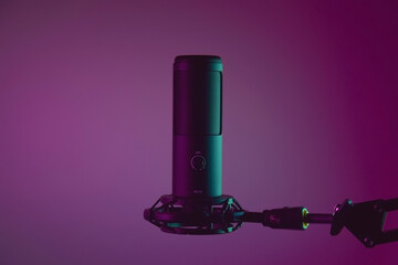 Studio condenser microphone isolated on dark background.