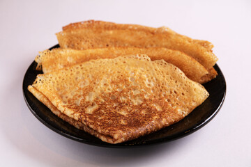photo pancakes in the form of a triangle lying on a plate