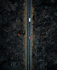 Vertical photo of the road with two cars with motion blur from above by drone - night time photo in...