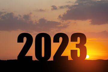 Silhouette 2023 with sunset sky at mountain and number like 2023 abstract background. Concept of...