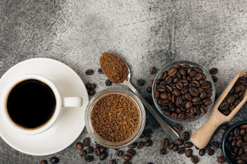 A cup of fragrant espresso coffee, instant coffee and coffee beans on a black stone background. Place for text. Space for copy text